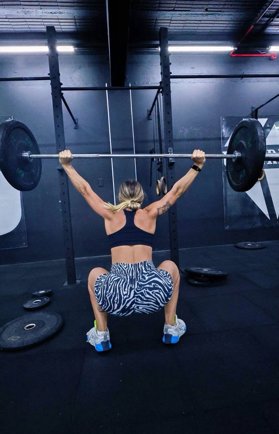 Mariana Sander realizando agachamento com barra acima da cabeça em um box de CrossFit